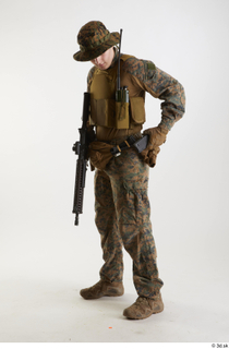 Casey Schneider in WDL Marpat Pose 5 loading gun standing…